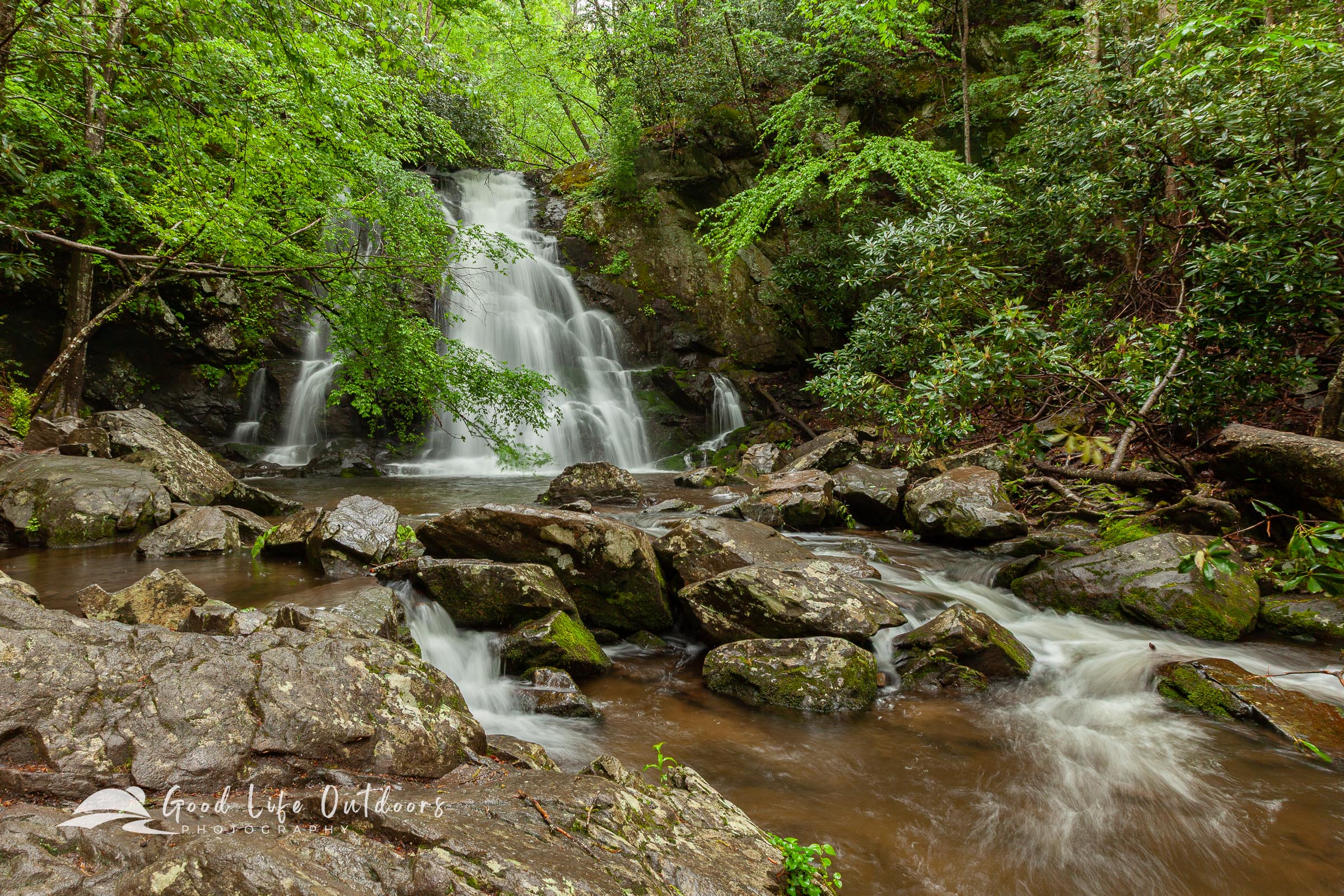 Water cascades down Spruce Flats Falls through the forest within Tennessee's Great Smoky Mountains National Park.