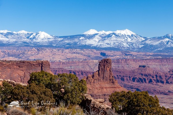 A beautiful view of colorful canyon rock with the snow capped La Sal Mountains in the background.